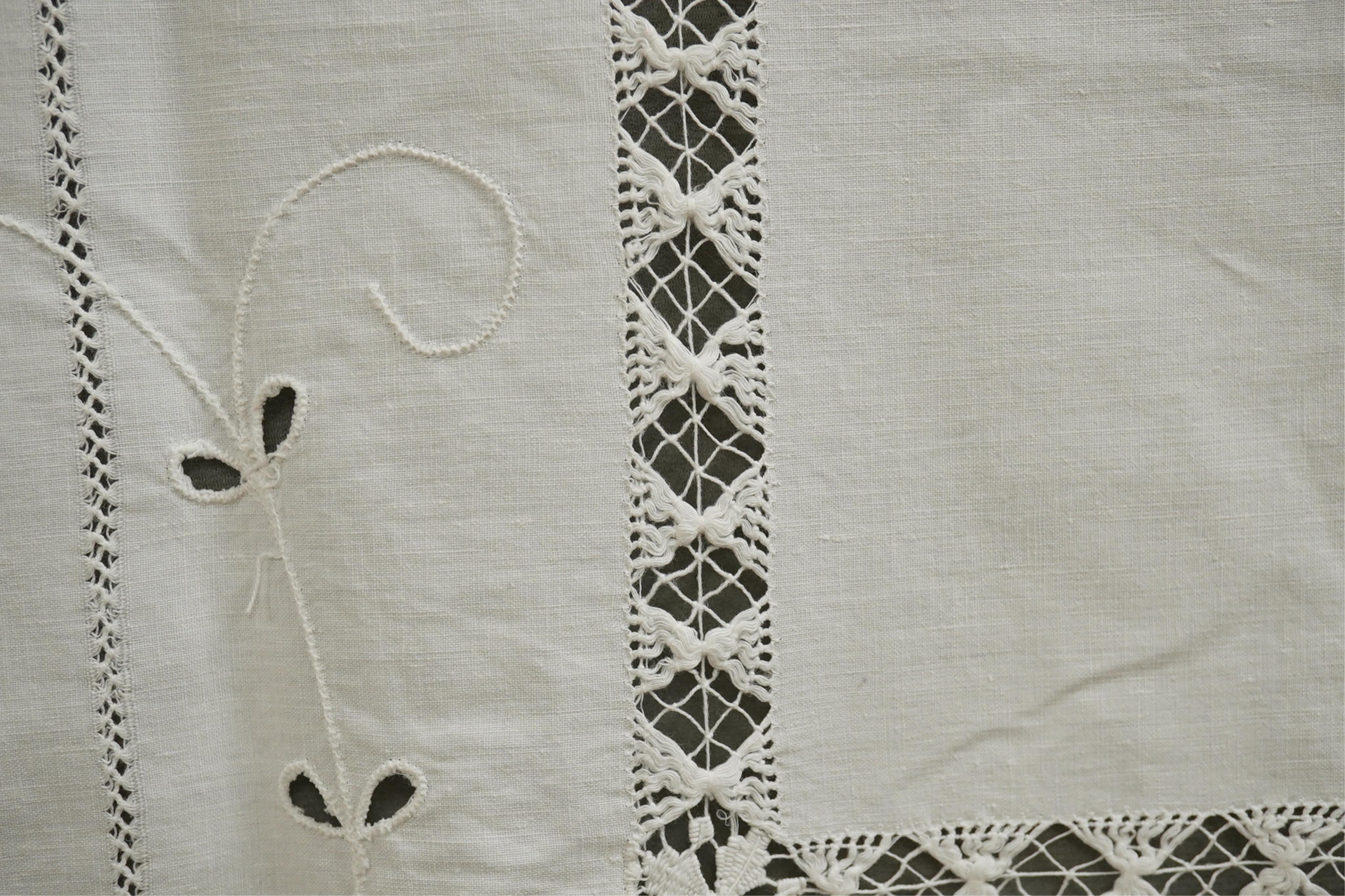 A collection of early 20th century and later crochet, cut work and drawn thread table linens and a large embroidered table cloth